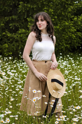 a lady in a white lace top and a brown high-waist skirt